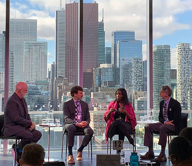 Three panelists and one moderator seated talking to each other